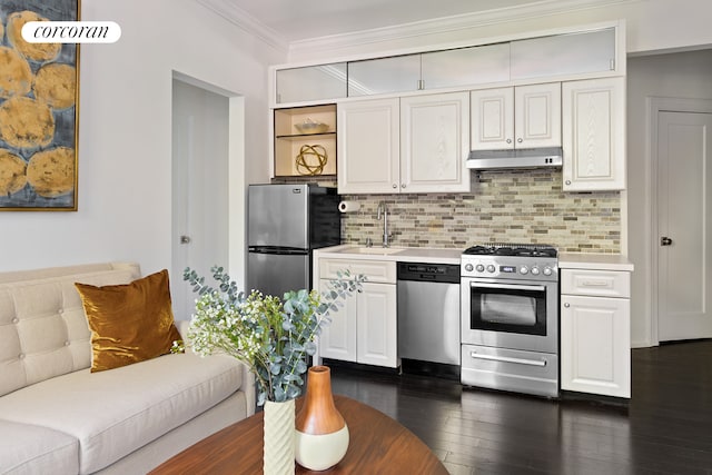 kitchen featuring light countertops, backsplash, appliances with stainless steel finishes, ornamental molding, and under cabinet range hood