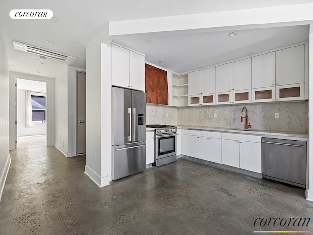 kitchen featuring visible vents, premium appliances, light countertops, concrete floors, and a sink