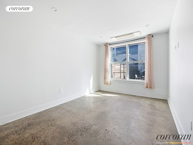 empty room featuring baseboards, visible vents, and concrete flooring