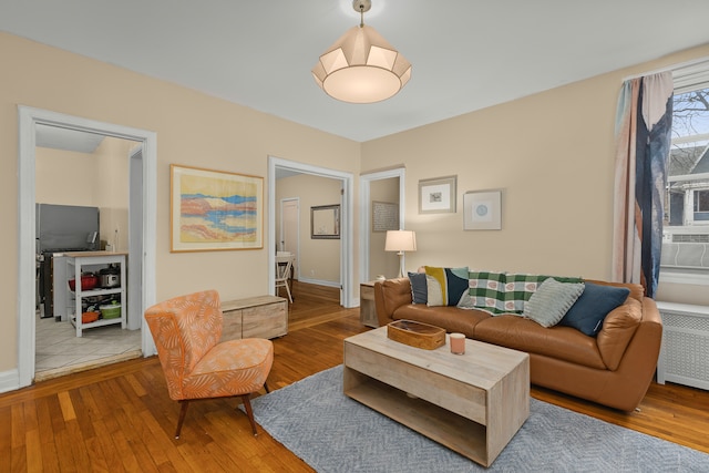 living area featuring hardwood / wood-style floors and radiator