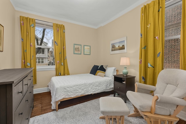 bedroom with dark wood-type flooring and baseboards