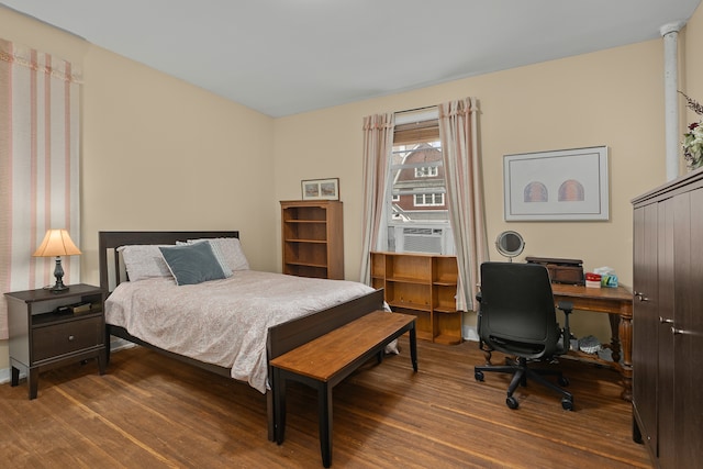 bedroom featuring cooling unit and wood finished floors