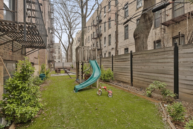 view of yard featuring a fenced backyard and a playground