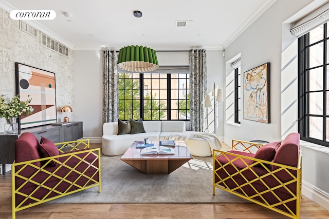 living room featuring plenty of natural light, ornamental molding, and wood finished floors