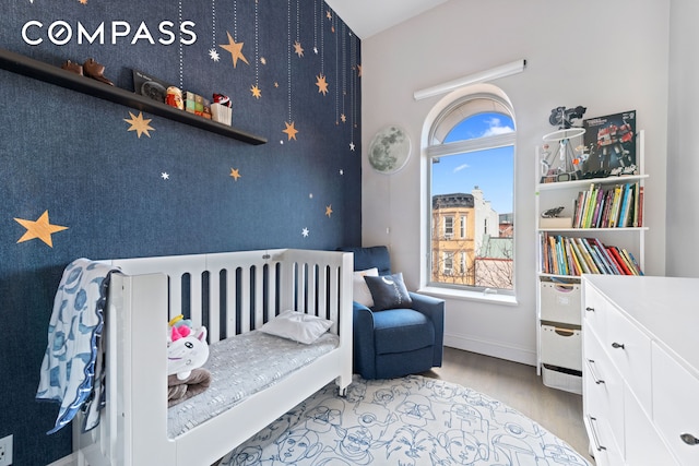 bedroom featuring wood finished floors and baseboards