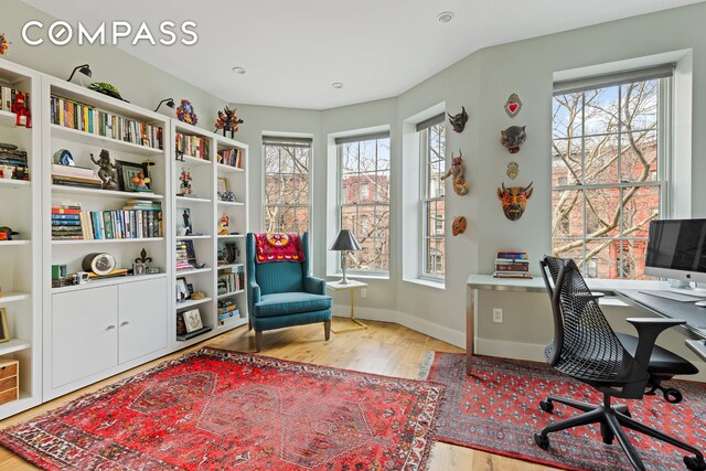 office featuring baseboards and wood finished floors