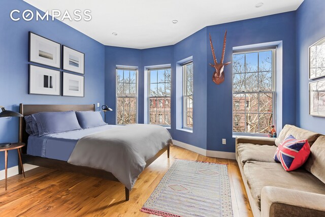 bedroom featuring baseboards and light wood-style floors