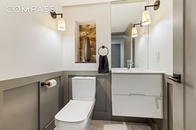 bathroom featuring vanity and toilet