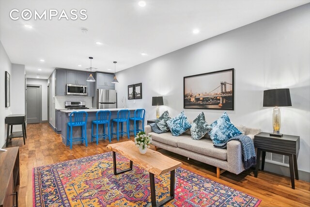 living room with recessed lighting and light wood-type flooring