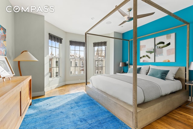 bedroom featuring baseboards and wood finished floors