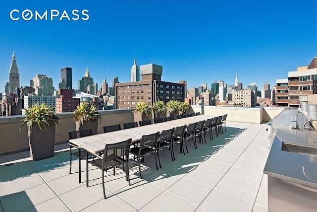 view of patio / terrace with a city view and a sink