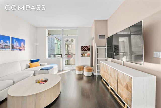 living area with dark wood-type flooring and visible vents