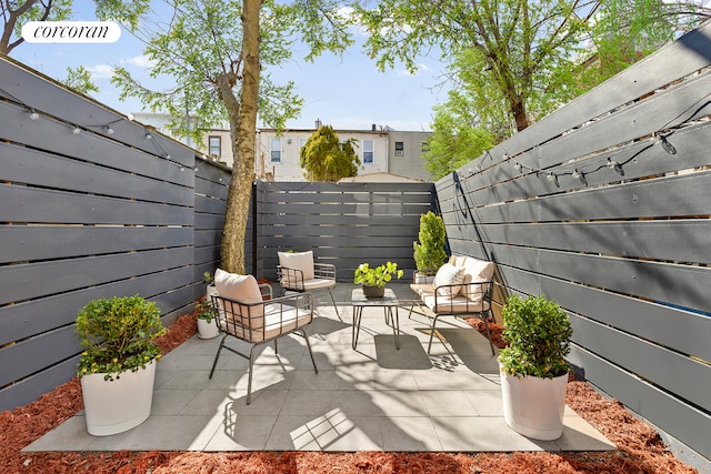 view of patio featuring a fenced backyard and outdoor lounge area