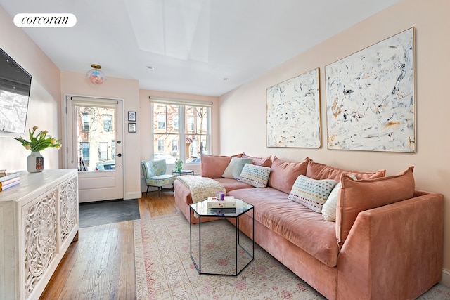 living area with hardwood / wood-style floors and visible vents