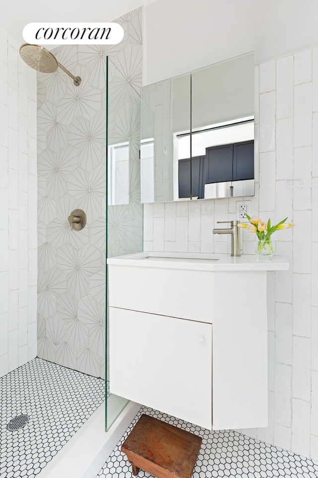 full bathroom featuring walk in shower and vanity