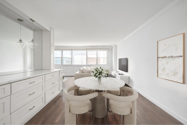 dining room featuring baseboards, ornamental molding, and dark wood finished floors