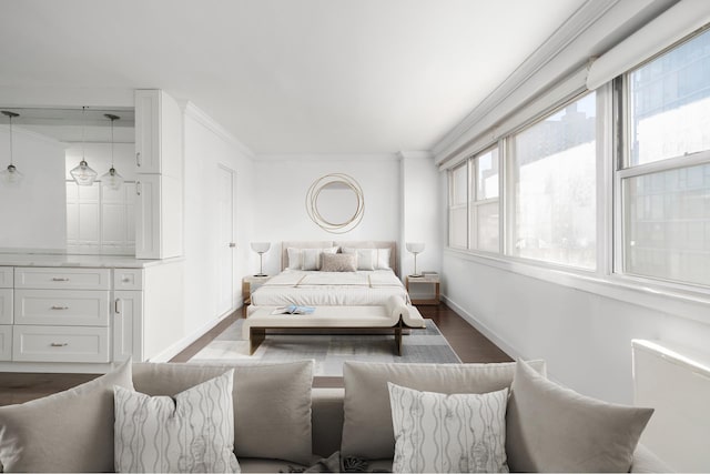 bedroom with dark wood finished floors, crown molding, and baseboards