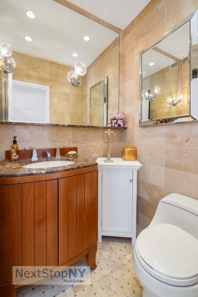 bathroom with toilet and tile walls