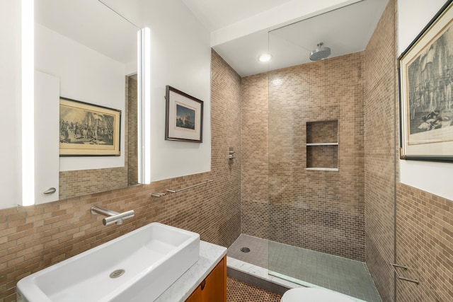 full bathroom featuring a walk in shower, toilet, vanity, and tile walls