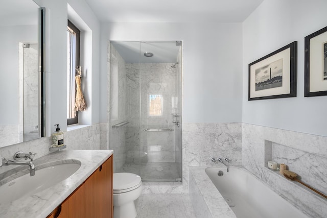 full bathroom featuring toilet, a shower stall, a bath, and vanity