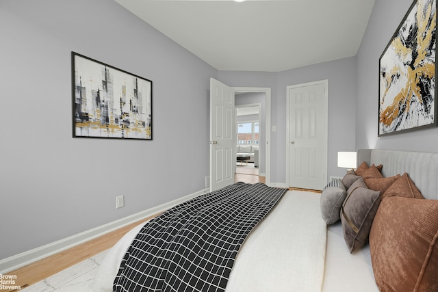 bedroom featuring wood finished floors and baseboards