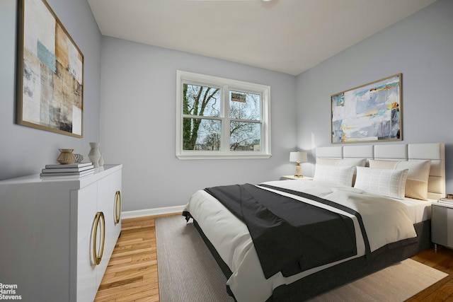 bedroom with light wood-style floors and baseboards