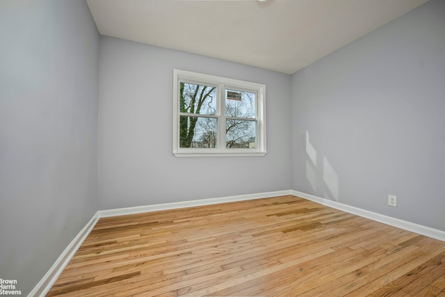 empty room with wood finished floors and baseboards