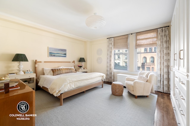 bedroom with dark wood-style floors