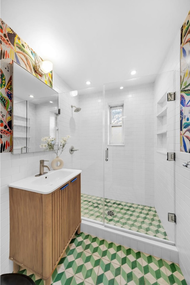 full bathroom with a shower stall, vanity, and recessed lighting