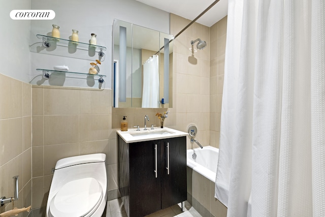 full bath with toilet, shower / bath combo with shower curtain, tile walls, and vanity