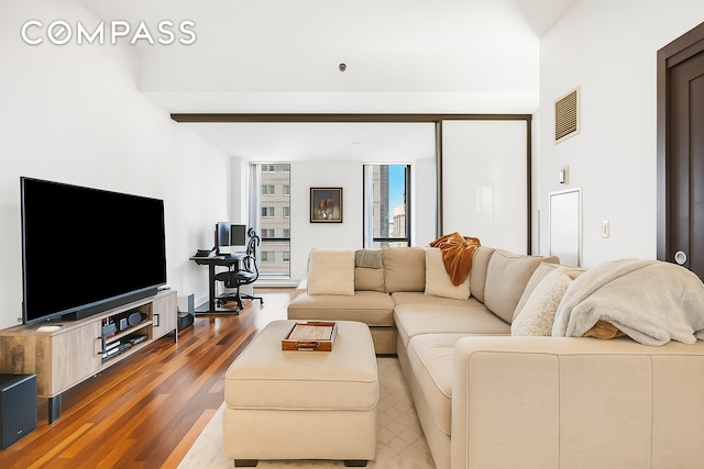 living room featuring visible vents and wood finished floors