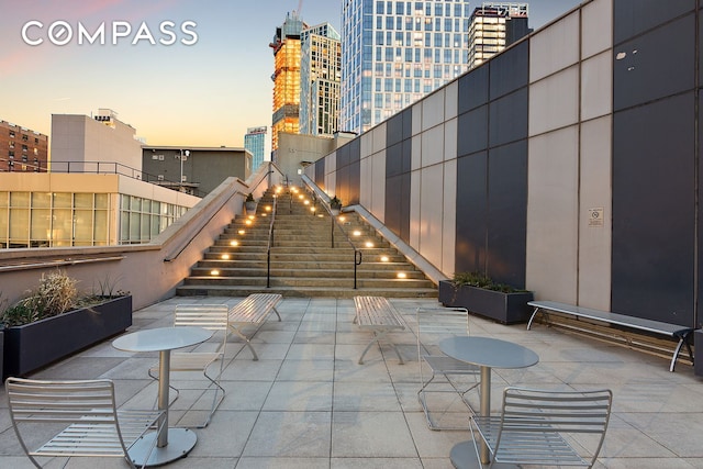 view of patio with a view of city and stairs