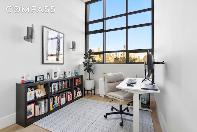 office area featuring wood finished floors and baseboards