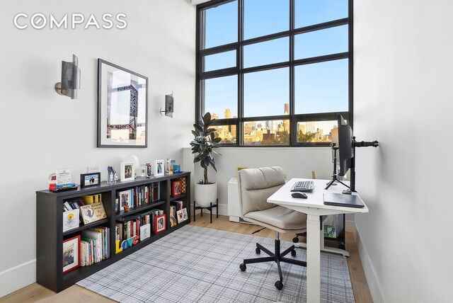 office space featuring baseboards and wood finished floors