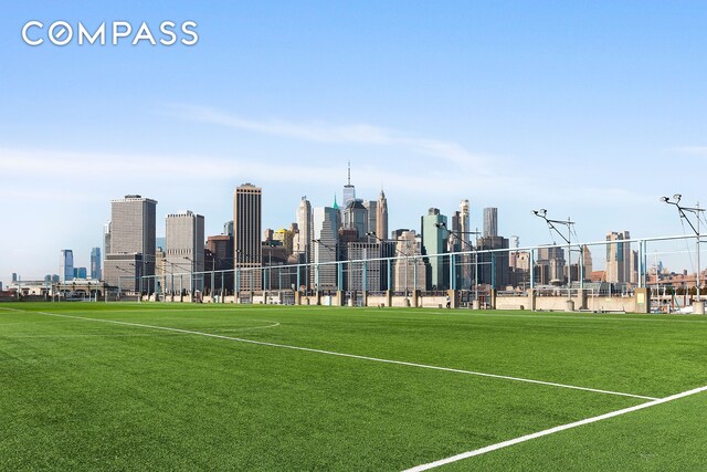 view of property's community featuring a view of city and fence