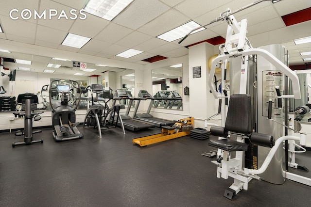 gym with a paneled ceiling