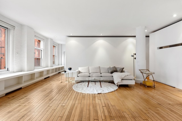 living area with recessed lighting and hardwood / wood-style floors