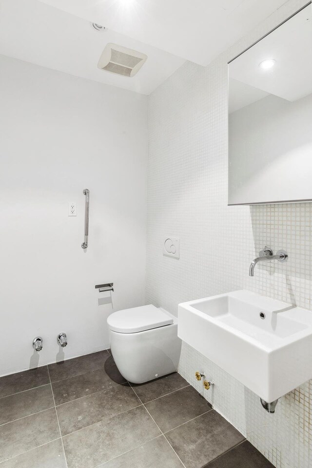 76 Laight St Unit 3, New York City, NY 10013 - bathroom with tile walls, tile patterned flooring, and decorative backsplash