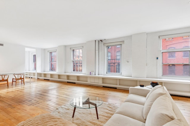 living room featuring visible vents and hardwood / wood-style flooring