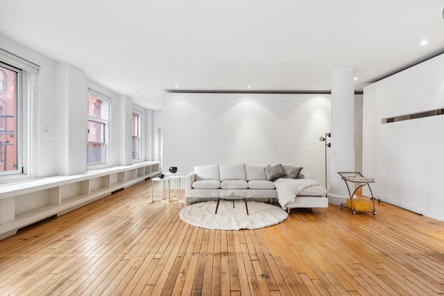 living area featuring recessed lighting and wood-type flooring