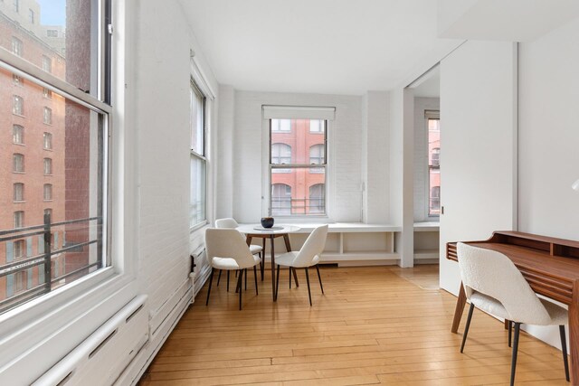 sitting room featuring light wood-style floors and baseboard heating