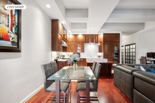 dining room featuring dark wood finished floors and baseboards