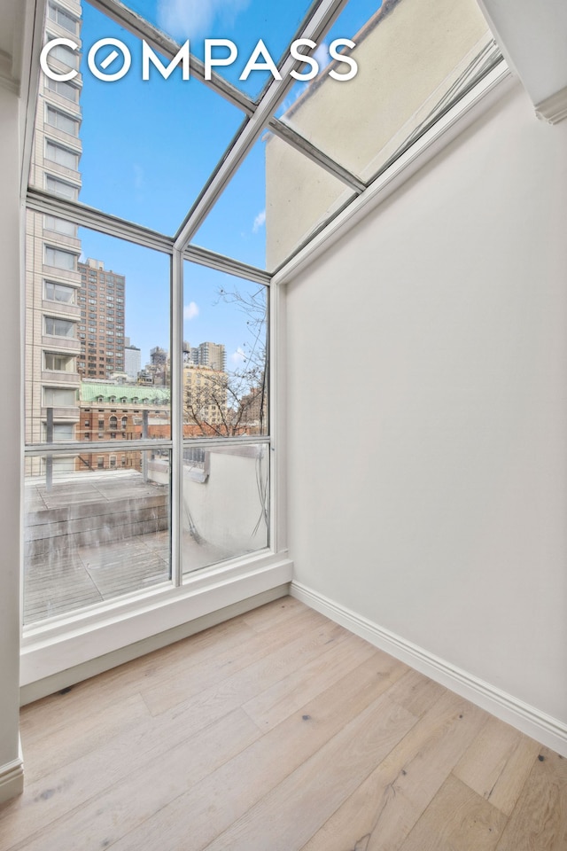 unfurnished sunroom with a view of city