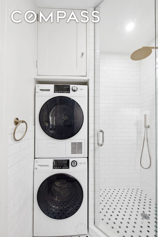 laundry area featuring stacked washer and dryer and laundry area