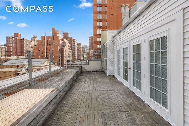 wooden terrace featuring a view of city and french doors