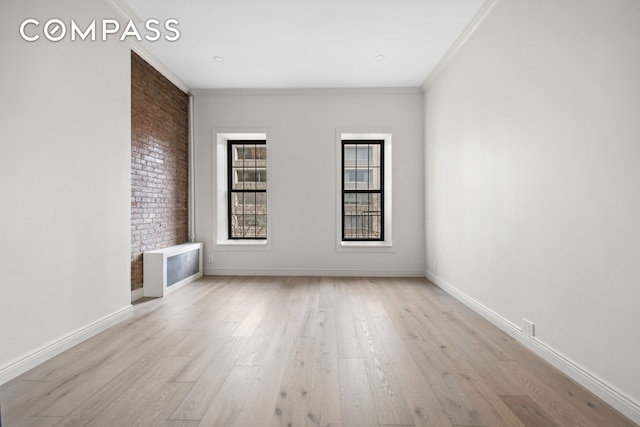 212 E 70th St Unit 4B, New York City, NY 10021 - unfurnished living room with wood finished floors, crown molding, and baseboards