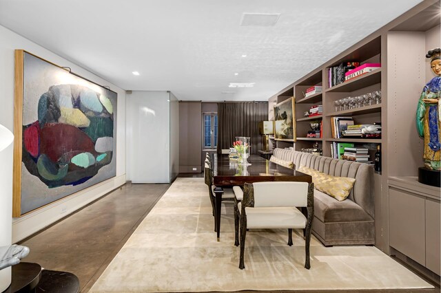 sitting room with built in shelves, recessed lighting, carpet floors, a fireplace, and crown molding