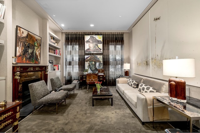 living area featuring built in shelves, carpet floors, a fireplace, recessed lighting, and ornamental molding