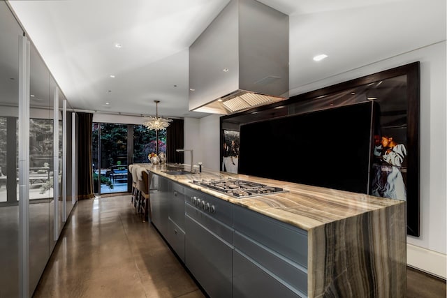 kitchen featuring light stone countertops, modern cabinets, a sink, and an inviting chandelier