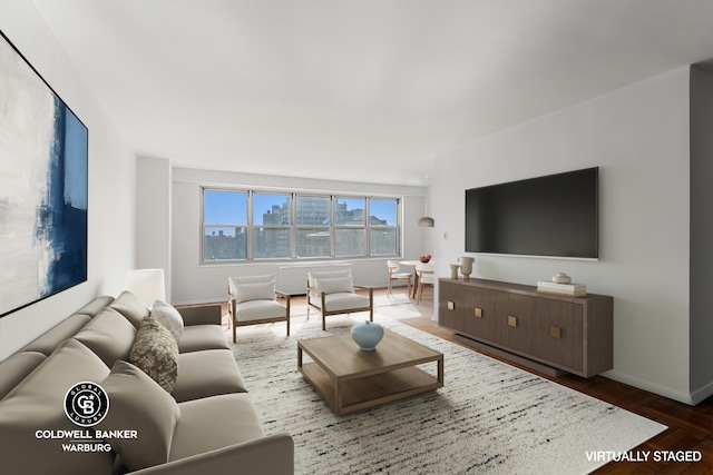 living room with baseboards and wood finished floors